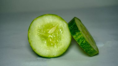 sliced cucumber on white background. preparing salad with cucumber.