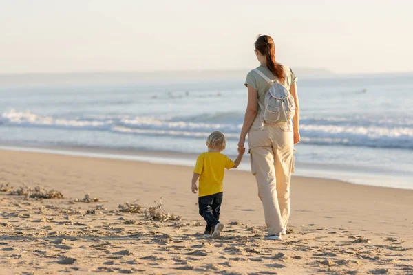 金发小男孩和他的母亲在海滩上散步 — 图库照片