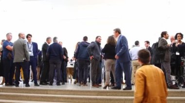 PORTUGAL, LISBON 09-11-2022: sage session at the Centro Cultural de Belem - people standing at the hall. Mid shot