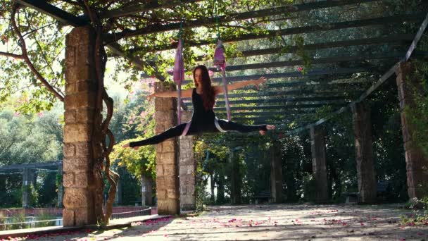 Aerial Yoga Woman Exercising Using Hanging Hammock Garden Mid Shot — Stockvideo