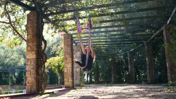 Woman Doing Aerial Yoga Outdoors Using Yoga Hammock Mid Shot — Video Stock