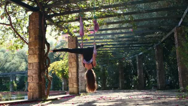 Woman Doing Aerial Yoga Outdoors Using Yoga Hammock Hanging Her — Stockvideo