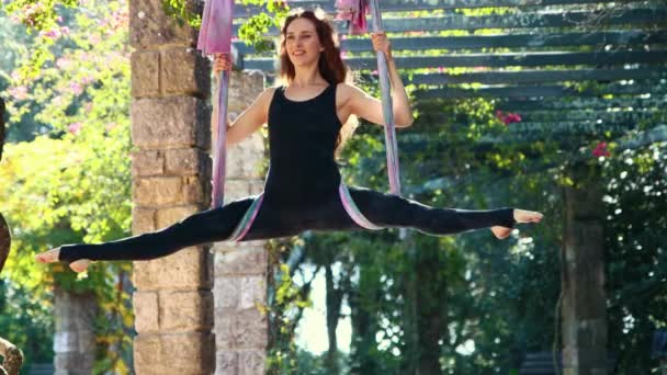 Woman Doing Aerial Yoga Exercises Outdoors Using Yoga Hammock Mid — Video Stock