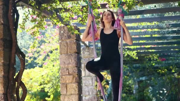 Smiling Woman Doing Aerial Yoga Using Hammock Mid Shot — Stock video