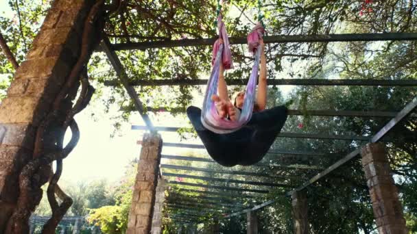 Woman Does Aerial Yoga Park Green Public Garden Mid Shot — Video
