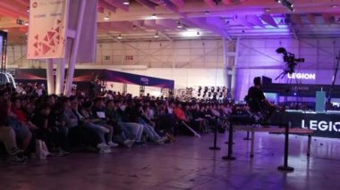 11-17-2022 LISBON, PORTUGAL - Lisboa Games Week 17 - people sit in front of the stage waiting for the presentation at gaming expo. Mid shot