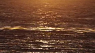 River water surface at an orange sunset. Mid shot