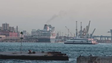 28 November 2022 LISBON, PORTUGAL: yacht sails against the backdrop of industrial plants. Mid shot