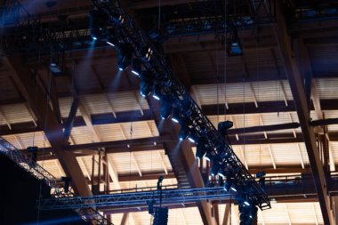 Lighting spotlights on structures under the ceiling. Mid shot