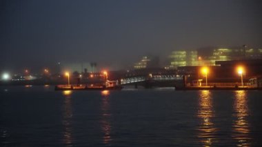 A pier by the foggy calm sea in the late evening. Mid shot