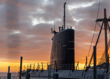 Submarine on the background of sunset. Mid shot