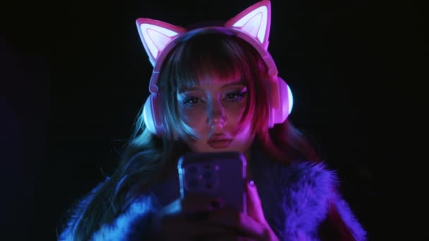 Cute Gamer Girl Wearing Headphones Luminous Cat Ears Playing Game — Stock video