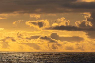 Bright yellow sunset over the dark sea. Mid shot