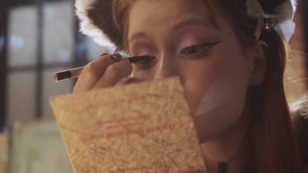 Ένα Χαριτωμένο Κορίτσι Κάνει Μακιγιάζ Σχέδιο Δραματική Φτερωτό Eyeliner Κοιτάζοντας — Αρχείο Βίντεο
