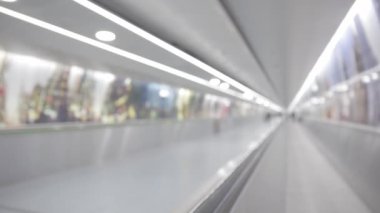 Empty moving walkway in the airport - blurred footage. Mid shot