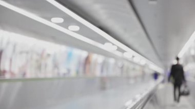 People walking on the travolator in the airport - blurred footage. Mid shot