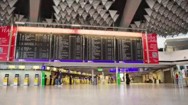 22-01-2023 Frankfurt, Germany: Departure scoreboard at the airport - people passing by. Time-lapse