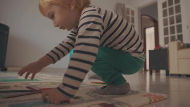 Cute Little Blonde Boy Collecting Colored Pencils Floor Mid Shot — Stock videók