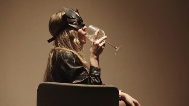 Woman Black Masquerade Mask Drinks Alcohol Glass Sitting Chair Mid — Stock Video