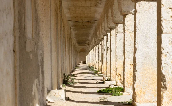 stock image Stone corridor in bright sunlight - Travel concept. Perspective