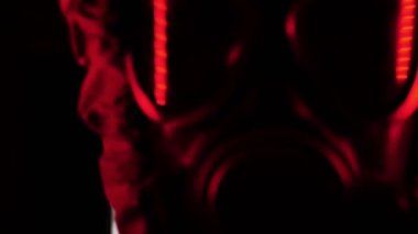 Kırmızı ışıklı gaz maskeli bir adam. Portre