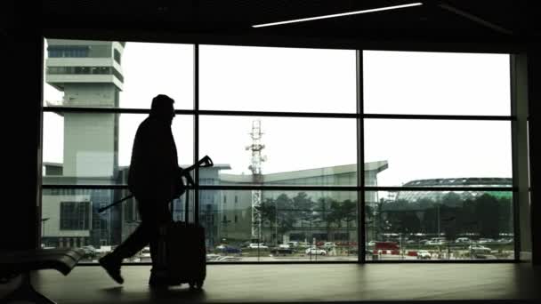 Sylwetki Zajętych Ludzi Spacerujących Lotnisku Przechodzących Obok Szklanej Ściany Środek — Wideo stockowe