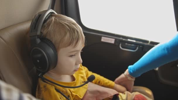 Little Boy Sitting Helicopter Wearing Headphones Mid Shot — Stock Video