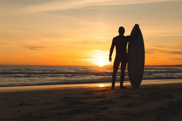 Ein Fitter Mann Der Strand Steht Und Sich Bei Sonnenuntergang — Stockfoto