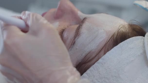 Meester Brengt Masker Aan Het Gezicht Van Haar Cliënt Met — Stockvideo