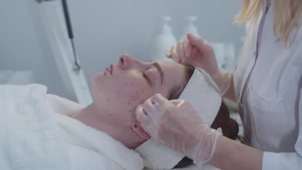 Лікування Косметології Майстер Після Процедури Протирає Шкіру Клієнтів Ватним Майданчиком — стокове відео