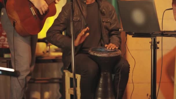 一个音乐团体在酒吧的舞台上表演 一个男人在演奏巴塔乐器 — 图库视频影像