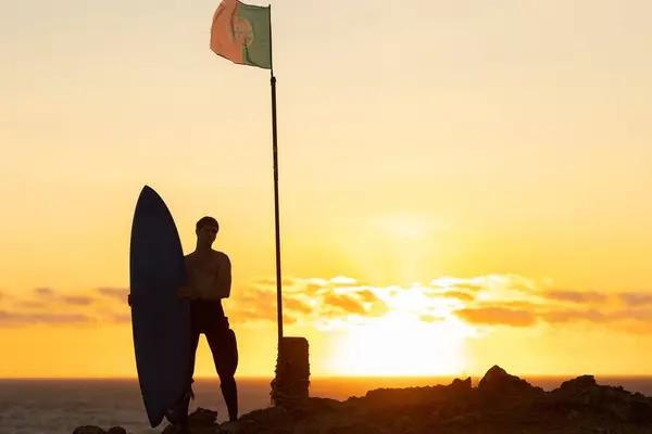 Silueta Hombre Parado Junto Océano Atardecer Sosteniendo Una Tabla Surf — Foto de Stock