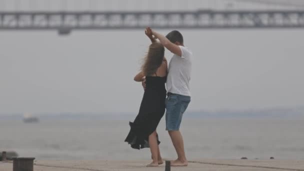 一对浪漫的已婚夫妇在码头上跳舞 背景是一座桥 — 图库视频影像