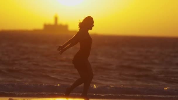 Silhueta Jovem Graciosa Vestido Dançando Praia Durante Pôr Sol Laranja — Vídeo de Stock