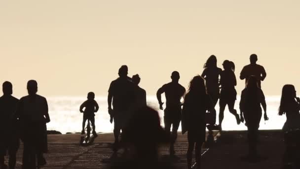 Спортивные Люди Бегут Ребенок Едет Велосипеде Моря Закате Толпе Людей — стоковое видео