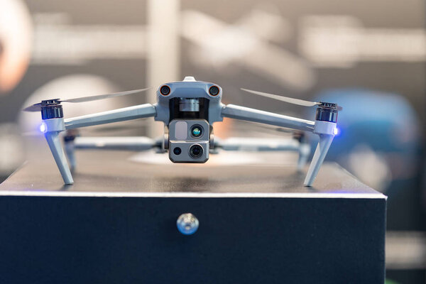 Advanced drone hovering with a prominent camera module beneath it.
