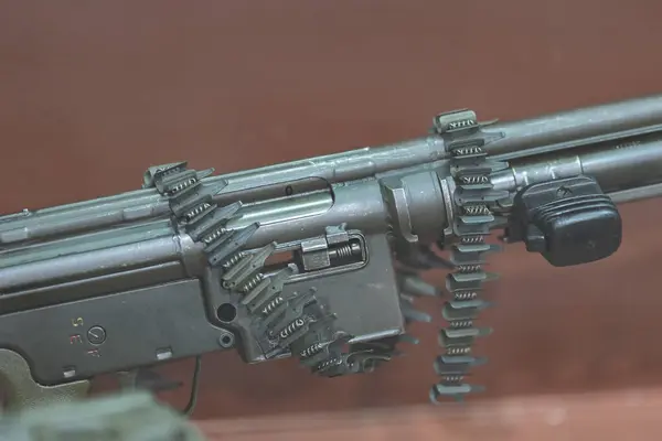 A close-up of a complex metallic weapon rifle with gears and intricate details.