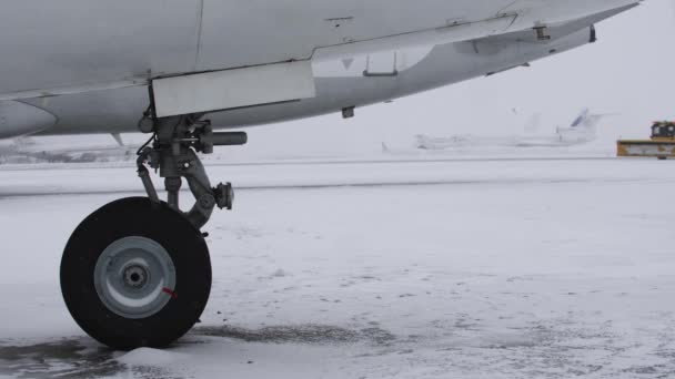 冬季飞机场 大客机在降雪时在机场上的转轮 — 图库视频影像