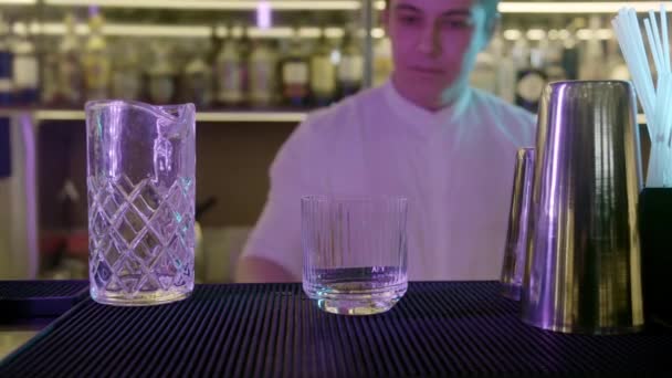 酒吧招待在玻璃酒吧或餐馆餐厅的环境中添加冰块 — 图库视频影像