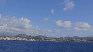 Azores adaları - güzel mavi gökyüzü birkaç bulutlu ve arka planda bir şehir. Şehir görüntünün sağ tarafında.