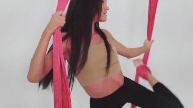 Hava jimnastiği. Üç genç kadın. Beyaz stüdyoda basketbol oynayıp bez asıyorlar. Orta çekim