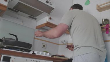 Ev aşçısı fırında et yemeği hazırlıyor.