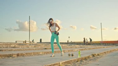 Sporcu kadın, Romanya 'nın dambıllarını kaldırıyor.