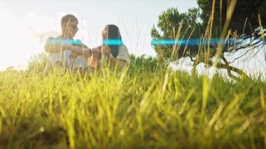 Çiftler doğada huzurlu bir anın tadını çıkarıyor, içkilerini ve sohbetlerini paylaşıyorlar.