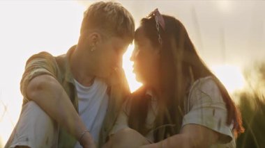 Romantik çift doğada huzurlu bir anın tadını çıkarıyor. Altın saat ışığıyla aydınlanıyor.