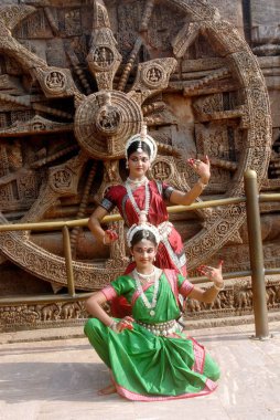 Dancers performing classical traditional odissi dance at Konarak Sun temple, Konarak, Orissa, India  clipart
