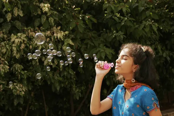 Stock image Ten years old Guajarati girl blowing out soap bubbles