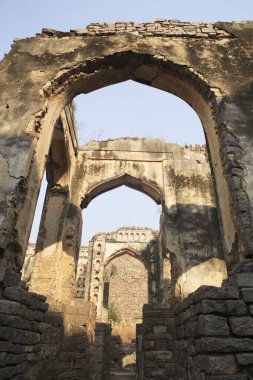 Golconda fort built by Mohammed Quli Qutb Shah 16th century view of ruined walls multiple arches , Hyderabad , Andhra Pradesh , India clipart