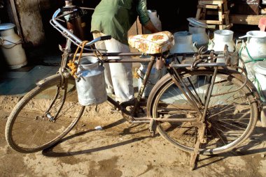 Bisiklet Mahesh Dairy Doodh Kendra, Bhuj, Kutch, Gujarat, Hindistan 'da alüminyum süt kutusu taşırdı. 