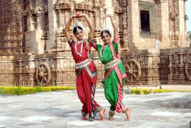 Dancers performing classical traditional odissi dance at Konarak Sun temple, Konarak, Orissa, India   clipart